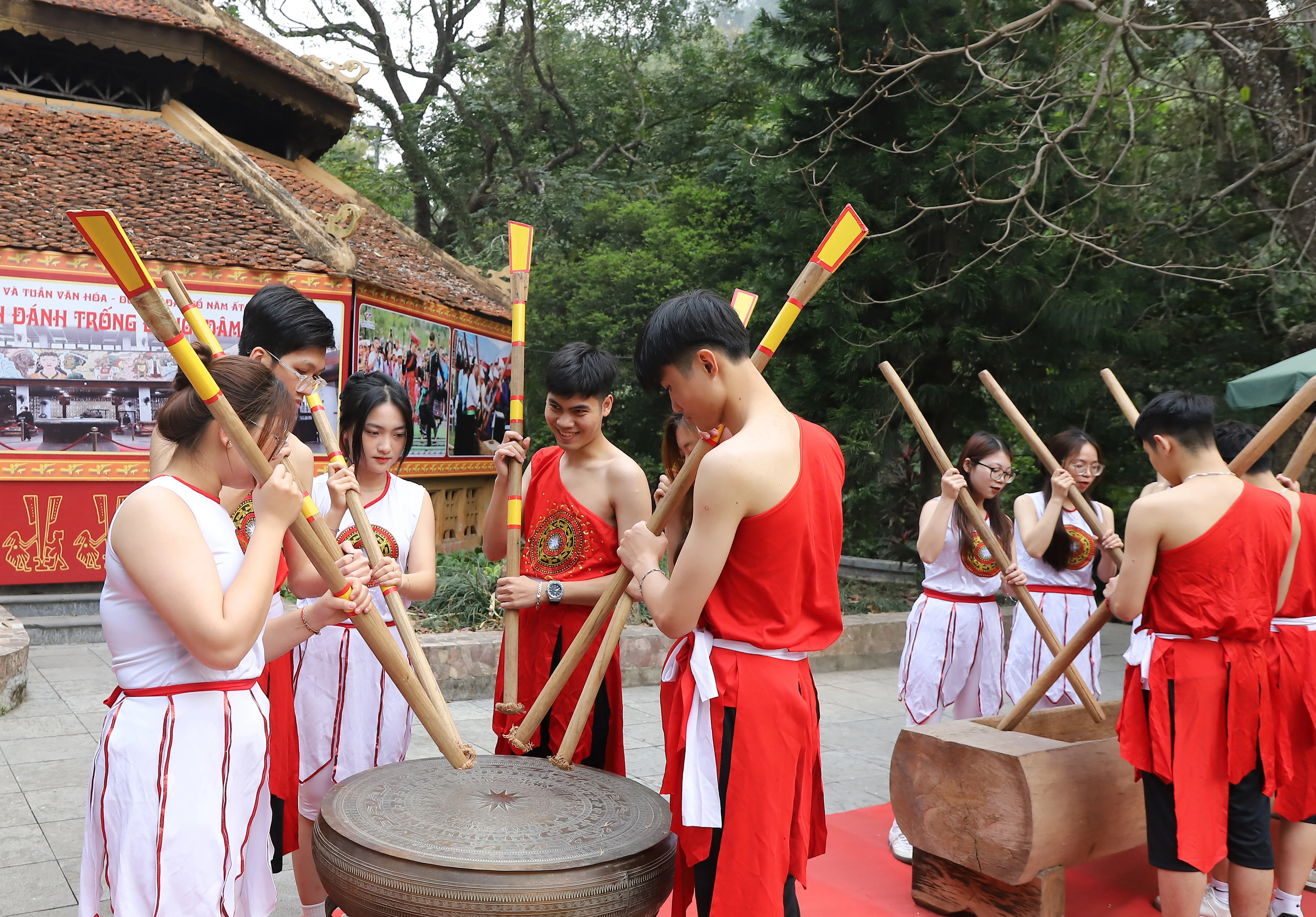 Bronze drum beating and bamboo pole stabbing performances for Hung Kings Commemoration Day